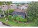 Aerial view of the pool with screened enclosure surrounded by lush landscaping in the backyard at 23346 Abercorn Ln, Land O Lakes, FL 34639