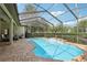 The screened in pool area includes a water feature and brick paver decking at 23346 Abercorn Ln, Land O Lakes, FL 34639