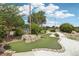 View of putting green with rock features and small water feature in a beautifully landscaped area at 23346 Abercorn Ln, Land O Lakes, FL 34639