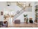 Elegant staircase with decorative iron railings and a view of the open concept living space at 23346 Abercorn Ln, Land O Lakes, FL 34639
