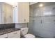Bathroom with glass-enclosed shower, tiled walls, and white cabinets at 2421 Eagle Chase Dr, Palm Harbor, FL 34683