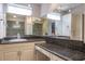 Bathroom with double sinks, granite counters, and large mirrors at 2421 Eagle Chase Dr, Palm Harbor, FL 34683