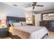 Spacious bedroom with a ceiling fan, carpeted floor, and dark wood furniture at 2421 Eagle Chase Dr, Palm Harbor, FL 34683