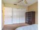Bedroom with closet doors, ceiling fan and dark colored furniture at 2421 Eagle Chase Dr, Palm Harbor, FL 34683