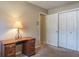 Simple bedroom with a closet, desk, and neutral wall paint at 2421 Eagle Chase Dr, Palm Harbor, FL 34683