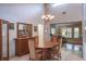 Dining room featuring a table, a large mirror, and views into the office and kitchen areas at 2421 Eagle Chase Dr, Palm Harbor, FL 34683