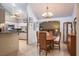 Open concept dining area adjacent to a kitchen with stainless steel appliances and stone countertops at 2421 Eagle Chase Dr, Palm Harbor, FL 34683