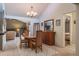 Inviting dining area with a chandelier, wood table and access to the living room at 2421 Eagle Chase Dr, Palm Harbor, FL 34683