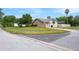 Well-maintained home exterior with a two-car garage, manicured lawn, and a serene corner lot at 2421 Eagle Chase Dr, Palm Harbor, FL 34683