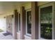 The entrance to the house showing the front door with windows on the porch with pillars at 2421 Eagle Chase Dr, Palm Harbor, FL 34683
