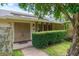 Inviting front entrance with a tiled walkway, lush landscaping, and a charming front door at 2421 Eagle Chase Dr, Palm Harbor, FL 34683