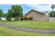 Well-manicured front yard with decorative rock garden and mature trees on a sunny day at 2421 Eagle Chase Dr, Palm Harbor, FL 34683