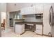Open kitchen with granite countertop, tile floors, and overhead cabinets at 2421 Eagle Chase Dr, Palm Harbor, FL 34683