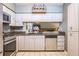 Well-lit kitchen with white cabinets, granite countertops, and modern stainless steel appliances at 2421 Eagle Chase Dr, Palm Harbor, FL 34683