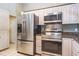 Stainless steel refrigerator, microwave, and stove in this home's kitchen at 2421 Eagle Chase Dr, Palm Harbor, FL 34683