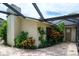The side of the home is enhanced with well-maintained landscaping and a screened-in patio at 2421 Eagle Chase Dr, Palm Harbor, FL 34683
