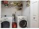 Functional laundry room featuring a washer, dryer, and storage shelves at 2421 Eagle Chase Dr, Palm Harbor, FL 34683