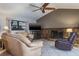 Living room featuring a stone fireplace, ceiling fan, and comfortable furniture at 2421 Eagle Chase Dr, Palm Harbor, FL 34683
