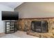 Living room with a stone fireplace and large television at 2421 Eagle Chase Dr, Palm Harbor, FL 34683
