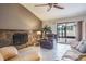 Inviting living room showcasing a stone fireplace and sliding glass doors at 2421 Eagle Chase Dr, Palm Harbor, FL 34683