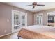 Main bedroom with ceiling fan and French doors to lanai at 2421 Eagle Chase Dr, Palm Harbor, FL 34683