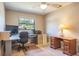 Bright home office with a desk, ceiling fan, and a window offering natural light at 2421 Eagle Chase Dr, Palm Harbor, FL 34683