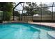 A captivating view of the stone-accented pool with a decorative tile trim at 2421 Eagle Chase Dr, Palm Harbor, FL 34683