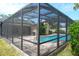 Aerial view of the screened-in pool area showing the pool, patio, and surrounding yard at 2421 Eagle Chase Dr, Palm Harbor, FL 34683