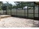 Spacious screened-in patio area overlooking the yard with stone accents and access to the backyard at 2421 Eagle Chase Dr, Palm Harbor, FL 34683