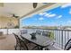 Spacious balcony with an iron dining set, offering serene views of the water at 3805 Gulf Blvd # 401, St Pete Beach, FL 33706