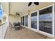 This is an airy balcony with a dining set and sliding glass doors, perfect for entertaining at 3805 Gulf Blvd # 401, St Pete Beach, FL 33706