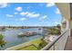 Stunning water view from a private balcony overlooking a boat dock and community pool at 3805 Gulf Blvd # 401, St Pete Beach, FL 33706