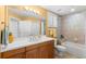 Bright bathroom with a vanity, ample counter space, and a shower-tub combination at 3805 Gulf Blvd # 401, St Pete Beach, FL 33706