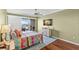 Bright bedroom with balcony access, mounted TV, and water views at 3805 Gulf Blvd # 401, St Pete Beach, FL 33706