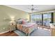 Cozy bedroom with a waterfront view, balcony access, and colorful bedspread at 3805 Gulf Blvd # 401, St Pete Beach, FL 33706