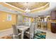 Open-concept dining area with seating for six, adjacent bar area, and stylish decor at 3805 Gulf Blvd # 401, St Pete Beach, FL 33706