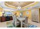 Bright dining room with seating for six, decorative ceiling, and adjacent bar area and balcony access at 3805 Gulf Blvd # 401, St Pete Beach, FL 33706