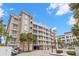 Exterior shot of a condo building with multiple balconies and well-maintained landscaping at 3805 Gulf Blvd # 401, St Pete Beach, FL 33706