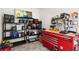 Well organized garage with shelves for storage, a peg board, and a red Husky tool chest at 3805 Gulf Blvd # 401, St Pete Beach, FL 33706
