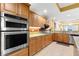 A modern kitchen showcases stainless steel appliances, granite countertops, and warm wood cabinetry at 3805 Gulf Blvd # 401, St Pete Beach, FL 33706