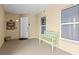 Cozy landing with decorative bench, window, and secure entry door at 3805 Gulf Blvd # 401, St Pete Beach, FL 33706