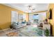 Bright living room with neutral tones, a ceiling fan, comfortable seating, and sliding glass doors to a balcony at 3805 Gulf Blvd # 401, St Pete Beach, FL 33706