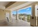 Inviting outdoor landing with rocking chairs and stunning views of tropical landscaping and ocean at 3805 Gulf Blvd # 401, St Pete Beach, FL 33706
