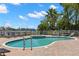 Community pool with a hot tub, surrounding lounge chairs, and views of the bay at 3805 Gulf Blvd # 401, St Pete Beach, FL 33706