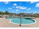 Community pool and hot tub surrounded by brick pavers with views of the bay and surrounding area at 3805 Gulf Blvd # 401, St Pete Beach, FL 33706