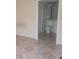 Bathroom showcasing a toilet and vanity, as viewed from the doorway of the adjacent room at 5125 Puritan Cir # 1103, Tampa, FL 33617