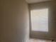 Bedroom interior featuring a window with blinds, ample natural light, and patterned tile flooring at 5125 Puritan Cir # 1103, Tampa, FL 33617