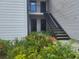 Condo exterior with stairs, showing doors and lush garden area at 5125 Puritan Cir # 1103, Tampa, FL 33617