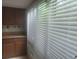 This kitchen view shows light entering through the window blinds at 5125 Puritan Cir # 1103, Tampa, FL 33617