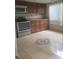 The updated kitchen features stainless steel appliances and bright tile flooring with a decorative motif at 5125 Puritan Cir # 1103, Tampa, FL 33617